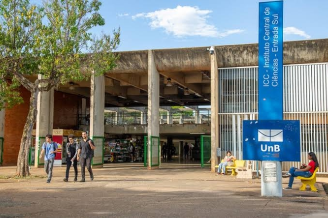 imagem realista do campus da UNB, alunos caminhanho e um dia lindo com céu limpo e poucas núvens